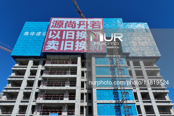 A large ''trade-in'' advertisement hangs on the outside of a commercial housing building under construction in Nanjing, China, on November 2...