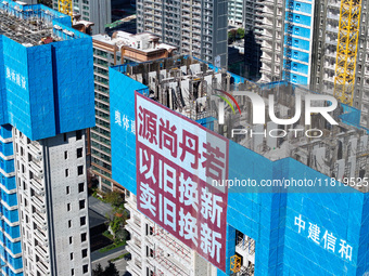 A large ''trade-in'' advertisement hangs on the outside of a commercial housing building under construction in Nanjing, China, on November 2...