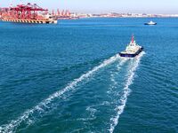 Auxiliary tugboats sail in the port area of Qingdao Port in Qingdao, China, on November 29, 2024. (