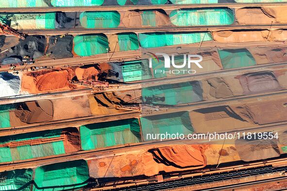 Imported iron ore is piled up at an iron ore yard in Qingdao Port in Qingdao, China, on November 29, 2024. 