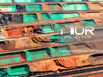 Imported iron ore is piled up at an iron ore yard in Qingdao Port in Qingdao, China, on November 29, 2024. (