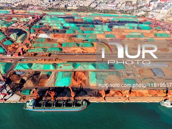 Imported iron ore is unloaded at a dock in Qingdao Port in Shandong province, China, on November 29, 2024. (