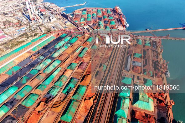 Imported iron ore is unloaded at a dock in Qingdao Port in Shandong province, China, on November 29, 2024. 