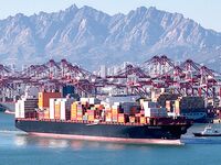 A cargo ship loaded with containers leaves the port of Qingdao in Qingdao, China, on November 29, 2024. (