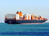 A cargo ship loaded with containers leaves the port of Qingdao in Qingdao, China, on November 29, 2024. (