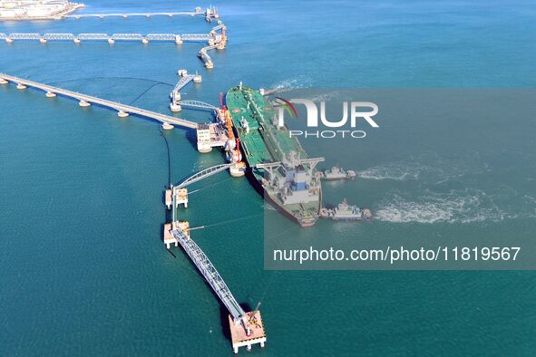 A foreign oil tanker prepares to leave the dock after unloading crude oil at the port of Qingdao in Shandong province, China, on November 29...