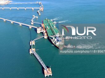 A foreign oil tanker prepares to leave the dock after unloading crude oil at the port of Qingdao in Shandong province, China, on November 29...