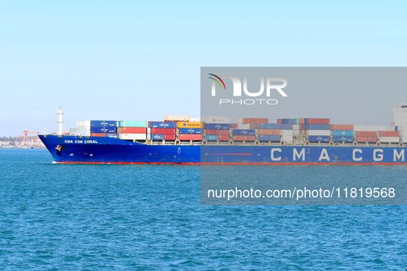 A fully loaded container ship enters the port of Qingdao in Qingdao, China, on November 29, 2024. 