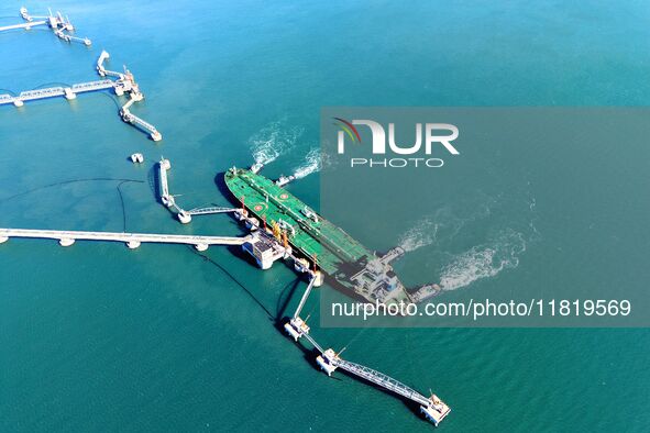 A foreign oil tanker prepares to leave the dock after unloading crude oil at the port of Qingdao in Shandong province, China, on November 29...