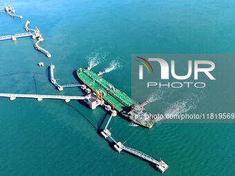 A foreign oil tanker prepares to leave the dock after unloading crude oil at the port of Qingdao in Shandong province, China, on November 29...