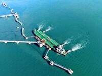 A foreign oil tanker prepares to leave the dock after unloading crude oil at the port of Qingdao in Shandong province, China, on November 29...