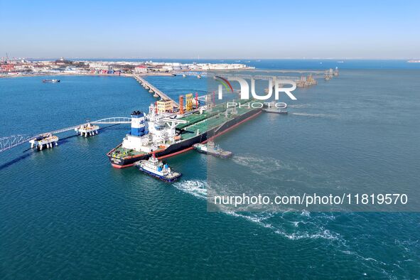 A foreign oil tanker prepares to leave the dock after unloading crude oil at the port of Qingdao in Shandong province, China, on November 29...