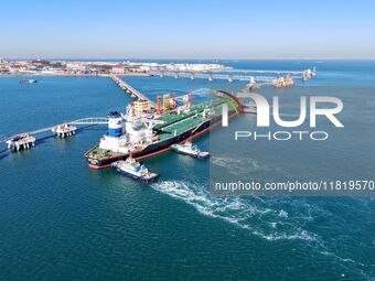 A foreign oil tanker prepares to leave the dock after unloading crude oil at the port of Qingdao in Shandong province, China, on November 29...