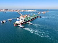 A foreign oil tanker prepares to leave the dock after unloading crude oil at the port of Qingdao in Shandong province, China, on November 29...