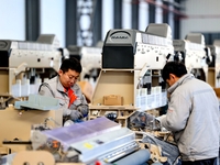 Workers produce shuttleless looms at a workshop in the West Coast New Area of Qingdao, Shandong province, China, on November 28, 2024. (