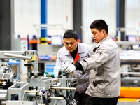 Workers produce shuttleless looms at a workshop in the West Coast New Area of Qingdao, Shandong province, China, on November 28, 2024. (