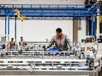 Workers produce shuttleless looms at a workshop in the West Coast New Area of Qingdao, Shandong province, China, on November 28, 2024. (