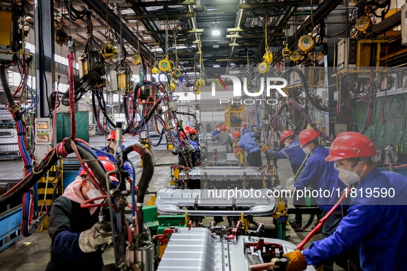 Workers produce shuttleless looms at a workshop in the West Coast New Area of Qingdao, Shandong province, China, on November 28, 2024. 