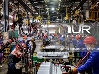 Workers produce shuttleless looms at a workshop in the West Coast New Area of Qingdao, Shandong province, China, on November 28, 2024. (