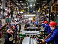 Workers produce shuttleless looms at a workshop in the West Coast New Area of Qingdao, Shandong province, China, on November 28, 2024. (