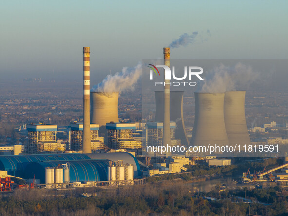 An aerial photo shows smoke from the chimney of the Huaneng Power plant in Huai 'an city, Jiangsu province, China, on November 29, 2024. 