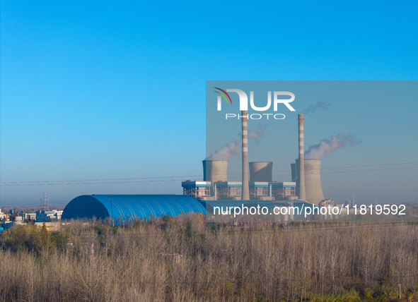 An aerial photo shows smoke from the chimney of the Huaneng Power plant in Huai 'an city, Jiangsu province, China, on November 29, 2024. 