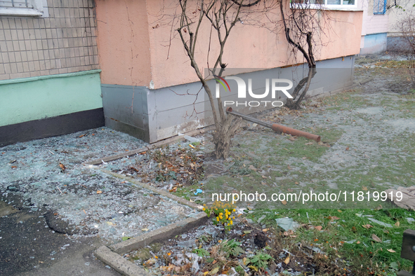 Glass shards cover the ground outside an apartment block damaged by an overnight Russian drone attack in the Dniprovskyi district of Kyiv, c...