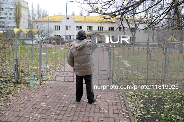 A man looks at a family polyclinic in the Dniprovskyi district damaged by an overnight Russian drone attack in Kyiv, Ukraine, on November 29...