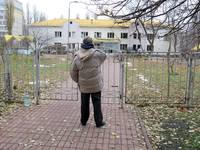 A man looks at a family polyclinic in the Dniprovskyi district damaged by an overnight Russian drone attack in Kyiv, Ukraine, on November 29...