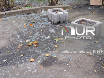 Glass shards cover the ground outside an apartment block damaged by an overnight Russian drone attack in the Dniprovskyi district of Kyiv, c...