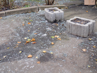 Glass shards cover the ground outside an apartment block damaged by an overnight Russian drone attack in the Dniprovskyi district of Kyiv, c...