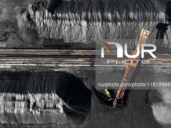 A bucket wheel machine works on a special railway line of the Jiangxi Coal Reserve Center in Jiujiang City, Jiangxi Province, China, on Nove...