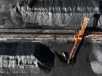 A bucket wheel machine works on a special railway line of the Jiangxi Coal Reserve Center in Jiujiang City, Jiangxi Province, China, on Nove...