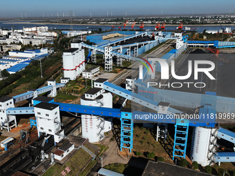 Electric coal loading operation takes place on the railway special line of Jiangxi Coal Reserve Center in Jiujiang, Jiangxi, China, on Novem...