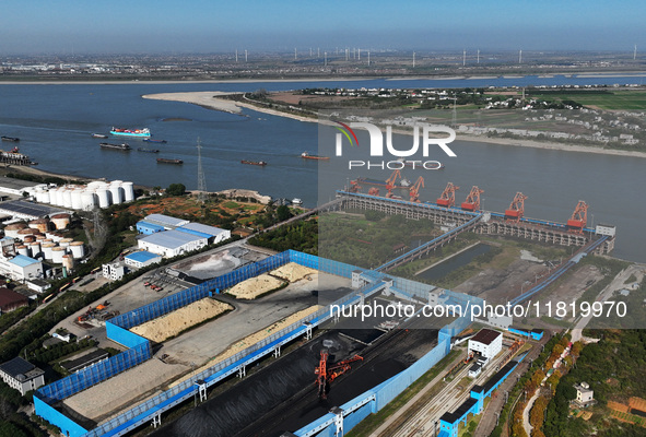 A bucket wheel machine works on a special railway line of the Jiangxi Coal Reserve Center in Jiujiang City, Jiangxi Province, China, on Nove...