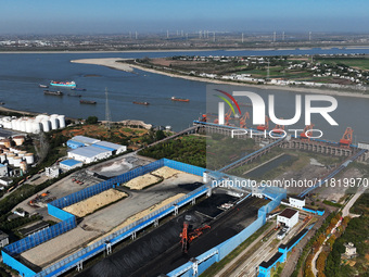 A bucket wheel machine works on a special railway line of the Jiangxi Coal Reserve Center in Jiujiang City, Jiangxi Province, China, on Nove...