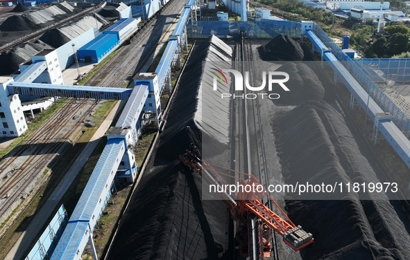 A bucket wheel machine works on a special railway line of the Jiangxi Coal Reserve Center in Jiujiang City, Jiangxi Province, China, on Nove...