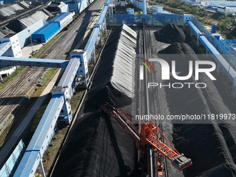 A bucket wheel machine works on a special railway line of the Jiangxi Coal Reserve Center in Jiujiang City, Jiangxi Province, China, on Nove...