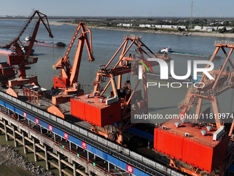 A cargo ship loaded with electric coal docks at the Yangtze River at the Jiangxi Coal and Carbon Reserve Center in Jiujiang City, Jiangxi Pr...