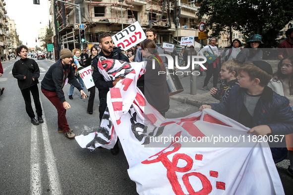 In Jerusalem, Israel, on November 29, 2024, Israeli police try to prevent demonstrators from marching as a group of Israeli demonstrators ca...