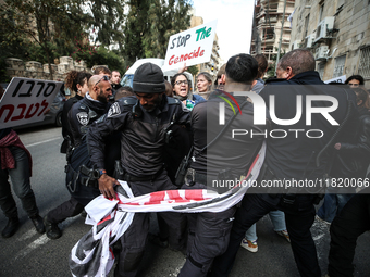 In Jerusalem, Israel, on November 29, 2024, Israeli police try to prevent demonstrators from marching as a group of Israeli demonstrators ca...