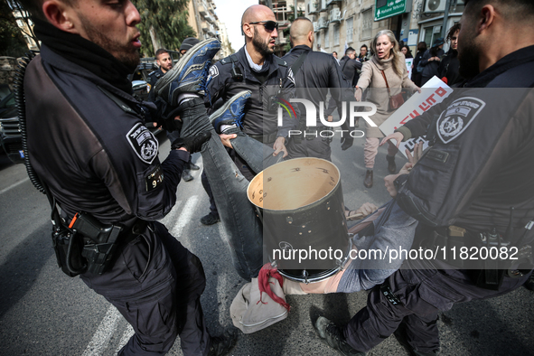 In Jerusalem, Israel, on November 29, 2024, Israeli police try to prevent demonstrators from marching as a group of Israeli demonstrators ca...