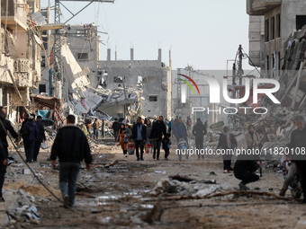 Palestinians inspect the destruction as displaced residents return to Nuseirat in the central Gaza Strip after Israeli shelling of the camp...