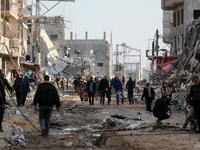 Palestinians inspect the destruction as displaced residents return to Nuseirat in the central Gaza Strip after Israeli shelling of the camp...