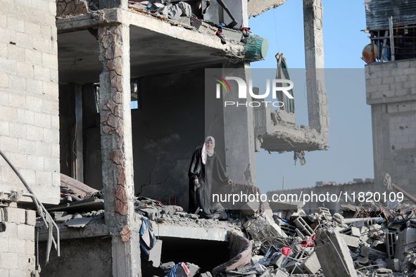 Palestinians inspect the destruction as displaced residents return to Nuseirat in the central Gaza Strip after Israeli shelling of the camp...