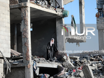 Palestinians inspect the destruction as displaced residents return to Nuseirat in the central Gaza Strip after Israeli shelling of the camp...