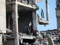 Palestinians inspect the destruction as displaced residents return to Nuseirat in the central Gaza Strip after Israeli shelling of the camp...