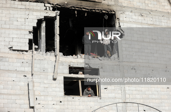 Palestinians inspect the destruction as displaced residents return to Nuseirat in the central Gaza Strip after Israeli shelling of the camp...