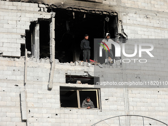 Palestinians inspect the destruction as displaced residents return to Nuseirat in the central Gaza Strip after Israeli shelling of the camp...