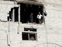 Palestinians inspect the destruction as displaced residents return to Nuseirat in the central Gaza Strip after Israeli shelling of the camp...